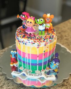 a birthday cake decorated with sesame street characters