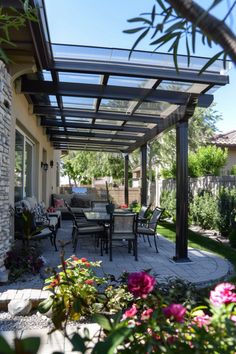 a patio covered in lots of furniture and flowers