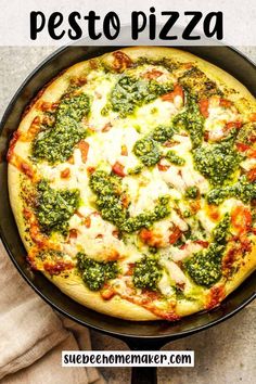 a pizza with broccoli and cheese in a pan on top of a table