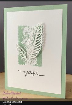 a handmade card with a white and green feather on the front that says catch