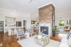 a living room filled with furniture and a fire place