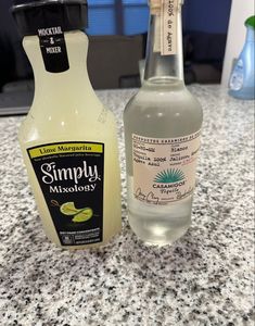 two bottles of lemonade sitting on top of a counter