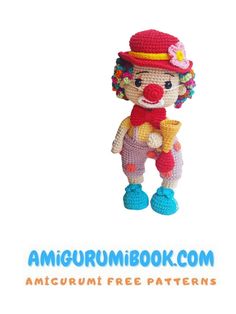 a crocheted clown doll hanging from a hook on a white background with the words amigurum book com written below it