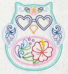 an embroidered owl with hearts and flowers on it