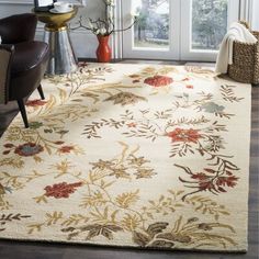 a white rug with red and yellow flowers on it