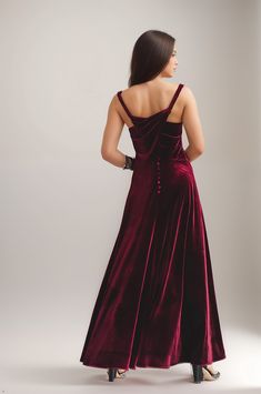 the back of a woman wearing a red velvet dress