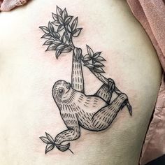 a slotty hanging from a tree tattoo on the back of a woman's stomach