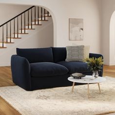 a living room with a blue couch and coffee table