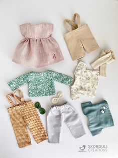 doll clothes laid out on a white surface