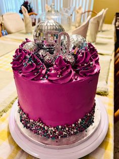 a cake with purple frosting and decorations on top