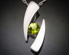 "Peridot and Argentium Silver Necklace - 3489 - Argentium Chain Included Make a statement with this contemporary design handcrafted by award winning designer, David Worcester. ( IMPORTANT - PLEASE READ 1. AND 2 BELOW ) 1.) INCLUDED IN THE PRICE IS AN ARGENTIUM SILVER CHAIN APPROPRIATE FOR THE PENDANT CHOSEN. YOU CAN CHOOSE FROM 16\", 18\" OR 20\" AT CHECKOUT. 2.) PLEASE LOOK AT THE MEASUREMENTS CAREFULLY. SOME PHOTOS HAVE BEEN ENLARGED TO SHOW DETAIL, WHILE OTHERS HAVE BEEN MINIMIZED TO FIT THE White Sapphire Necklace, Argentium Silver Jewelry, Award Winning Jewelry, Yucca Valley, Fine Gold Jewelry, Peridot Jewelry, Peridot Pendant, Peridot Necklace, Fine Silver Jewelry