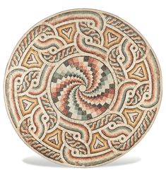 an intricately designed ceramic plate on a white background