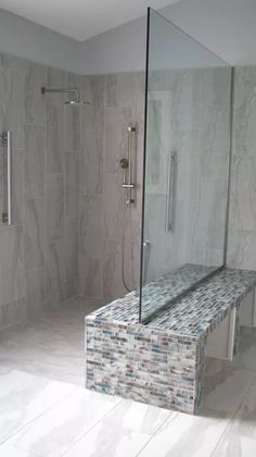 a walk in shower sitting inside of a bathroom next to a tiled wall and floor