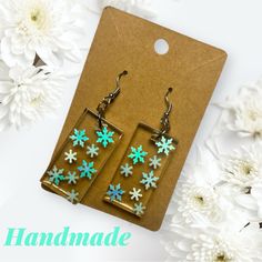 the earrings are decorated with snowflakes on them and hanging from earwires