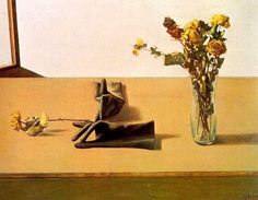 a vase filled with yellow flowers next to a pair of shoes