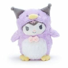 a small stuffed animal wearing a purple and white outfit with horns on it's head