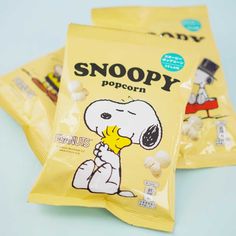 three bags of snoopy popcorn sitting on top of each other