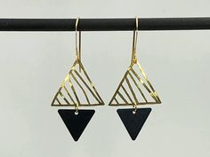 "This pair of modern geometric earrings are made of two abstract triangles in contrasting colors and opposite directions. The delicate gold triangles are hammered by hand with care. Along with the 22K gold plated earring hooks, it is lightweight and comfortable -- a perfect gift for every day or an evening out! Item Details * Total length of earrings: 1 3/4\" including earring hooks * Earring hooks: 22K gold plated * Big triangles: Hand hammered. 3/4\" high and 3/4\" wide * Small Triangles: Oxid Modern Black Geometric Earrings, Modern Geometric Ear Wire Earrings, Modern Black Triangle Jewelry, Phoenix Jewelry, Gold Filigree Earrings, Earrings Triangle, Bridesmaid Earrings Gold, Cobalt Blue Earrings, Gold Bridesmaids