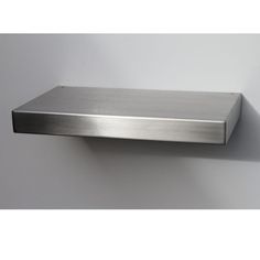 a stainless steel shelf mounted on the wall