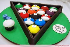 a cupcake shaped like a triangle with pool balls in it