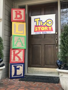 the front door of a two story house decorated with blocks