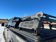 the truck is parked on the side of the road with its roof rack mounted to it's flatbed