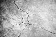 an old cracked concrete wall with cracks in it