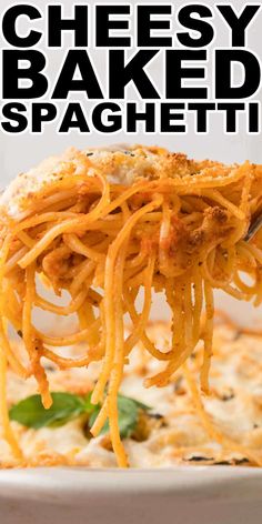 cheesy baked spaghetti is being lifted from a casserole dish in a white bowl