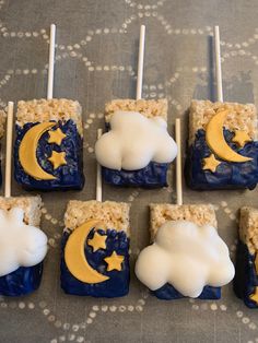 six marshmallows decorated with moon and clouds