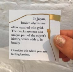 someone holding up a piece of paper with gold foil on it that says in japan, broken objects are often repaired with gold