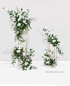 two tall gold poles with white flowers and greenery