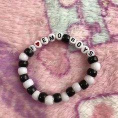 a black and white beaded bracelet with the words i love boys written on it