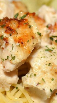 closeup of chicken and pasta with parmesan cheese on the side, ready to be eaten