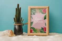 a potted plant sitting next to a frame with the words love summer written on it