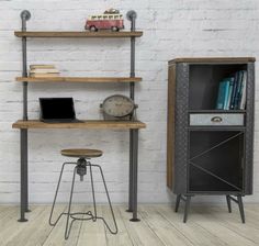 a computer desk sitting next to a book shelf on top of a hard wood floor