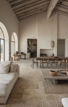 a living room filled with furniture and windows