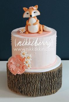 a cake decorated with a fox and flowers