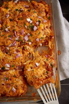 a casserole dish with meat, onions and cheese