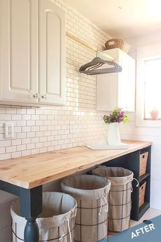 an image of a laundry room with buckets on the counter and two trash cans