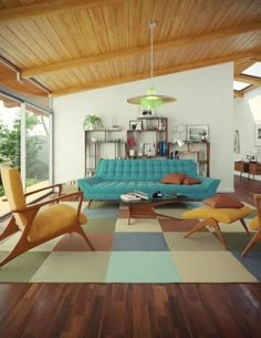 a living room filled with furniture next to a large window and lots of bookshelves