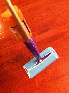 a close up of a cleaning mop on a wooden floor