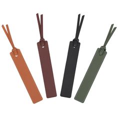 four different colors of luggage tags with leather handles and ties on each side, one is black, the other is brown