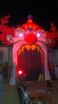 an elaborately decorated entrance to a building at night with red lights on the door