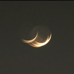 two crescents are seen in the night sky with no light on them, and one is