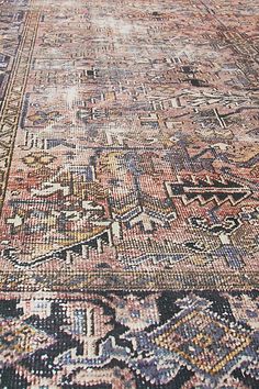 an old rug with many different colors and patterns