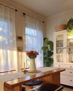 a dining room table and chairs in front of a window