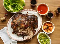 a table topped with plates and bowls filled with different types of food on top of it