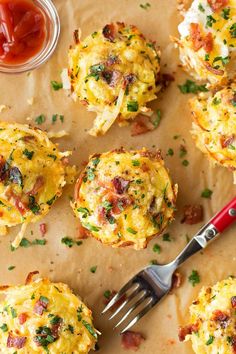 mini frittatas with bacon and cheese on parchment paper next to ketchup