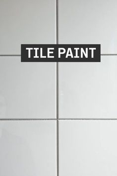 a tile wall with a black and white sign that says tile paint on the side