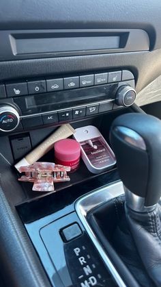 the interior of a car with various items in it's center console and dash board